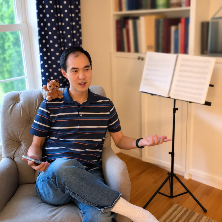 Ben Chan sitting near a music stand while using Violin for Parents